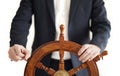 Businessman holding ship rudder isolated on white.