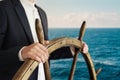 Businessman holding ship rudder and navigates Royalty Free Stock Photo