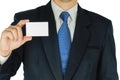 Businessman is holding or showing blank white card over white background. Royalty Free Stock Photo