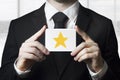 Businessman holding sign rating star gold