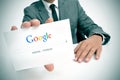 Businessman holding a signboard with the Google search home page