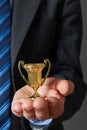 Businessman Holding Small Trophy Royalty Free Stock Photo