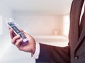 Businessman holding smart phone with media icons. Royalty Free Stock Photo