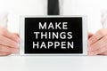 Businessman holding a smart tablet with sign Make things happen on screen Royalty Free Stock Photo