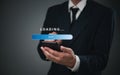 Businessman holding a smartphone with a digital loading progress bar. Ideal for mobile app development