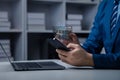 Businessman is holding smartphone with hologram, manipulating smartphone control. Royalty Free Stock Photo