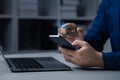 Businessman is holding smartphone with hologram, manipulating smartphone control. Royalty Free Stock Photo