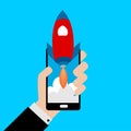 Businessman holding a smartphone with a rocket.Concept of Start up. Royalty Free Stock Photo