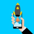 Businessman holding a smartphone with a rocket.Concept of Start up. Royalty Free Stock Photo
