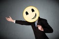 Businessman holding a smiley face emoticon