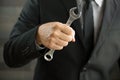 Businessman holding spanner in hand