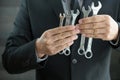 Businessman holding spanner in hand