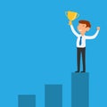 Businessman holding successful trophy on bar graph