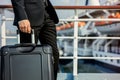 businessman holding a suitcase, cruise ship railing backdrop Royalty Free Stock Photo