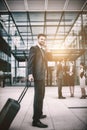 Businessman holding suitcase talking on mobile phone Royalty Free Stock Photo