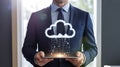 Businessman Holding Tablet with Cloud and Binary Data Royalty Free Stock Photo