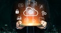 Businessman Holding Tablet with Cloud Technology Icons Representing Data Storage, Backup, Security, Network Connection Royalty Free Stock Photo