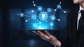 Businessman Holding a Tablet with Digital Brain Network Visualization and Technology Icons in a Modern Office Royalty Free Stock Photo