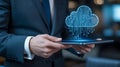 Businessman holding tablet with glowing digital cloud computing icon Royalty Free Stock Photo