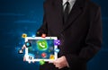 Businessman holding a tablet with modern colorful apps and icons Royalty Free Stock Photo