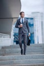 Business man walking down the street of a big city Royalty Free Stock Photo