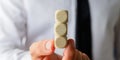 Businessman holding three stacked blank wooden dices