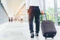 Businessman holding trolley bag going up on travel Royalty Free Stock Photo