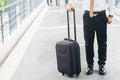 Businessman holding trolley bag going up on travel Royalty Free Stock Photo