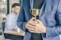 Businessman holding trophy award for success in business, Royalty Free Stock Photo