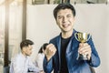 Businessman holding trophy award for success in business, Royalty Free Stock Photo