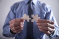 Businessman holding two jigsaw puzzle piece. Success and Business Royalty Free Stock Photo