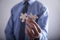 Businessman holding two jigsaw puzzle piece. Success and Business Royalty Free Stock Photo