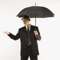 Businessman holding umbrella