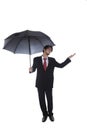 Businessman holding umbrella with hand held out Royalty Free Stock Photo