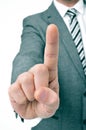 Businessman holding up his index finger