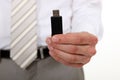 Businessman holding USB stick