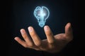 Businessman holding virtual light bulb and half brain on blue bokeh background smart thinking concept and innovative ideas Royalty Free Stock Photo