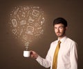 Businessman holding a white cup with social media icons Royalty Free Stock Photo