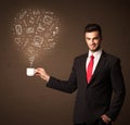 Businessman holding a white cup with social media icons Royalty Free Stock Photo