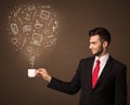 Businessman holding a white cup with social media icons Royalty Free Stock Photo