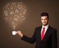 Businessman holding a white cup with social media icons Royalty Free Stock Photo