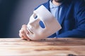 Businessman holding white mask in his hand Royalty Free Stock Photo