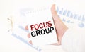 Businessman holding a white notepad with text FOCUS GROUP, business concept Royalty Free Stock Photo