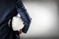 Businessman holding white safety helmet. Royalty Free Stock Photo