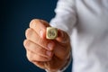 Businessman holding wooden dice with % sign