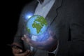 Businessman holding the world in the palm of hands concept for global business, communications, politics or environmental Royalty Free Stock Photo