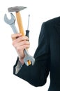 Businessman holding wrench, hammer and screwdriver