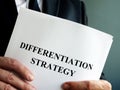 Businessman holds differentiation strategy.