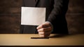 Businessman holds envelope in hand above vote ballot , Election and democracy concept. Royalty Free Stock Photo
