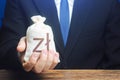 A businessman holds in his hand a polish zloty money bag. Stimulating economic recovery. Providing business with preferential Royalty Free Stock Photo